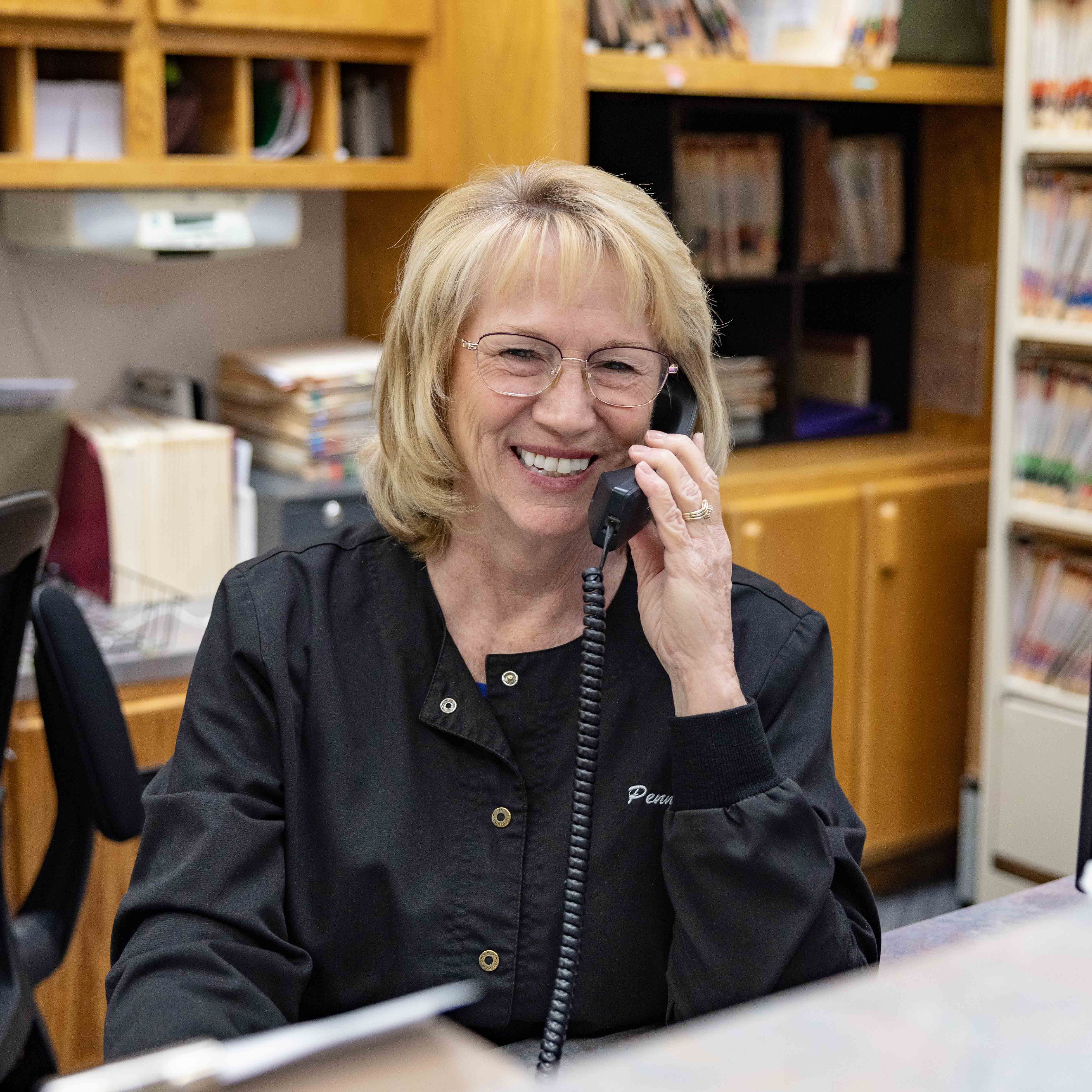 Front-desk staff member at Bingham Dentistry answering the phone