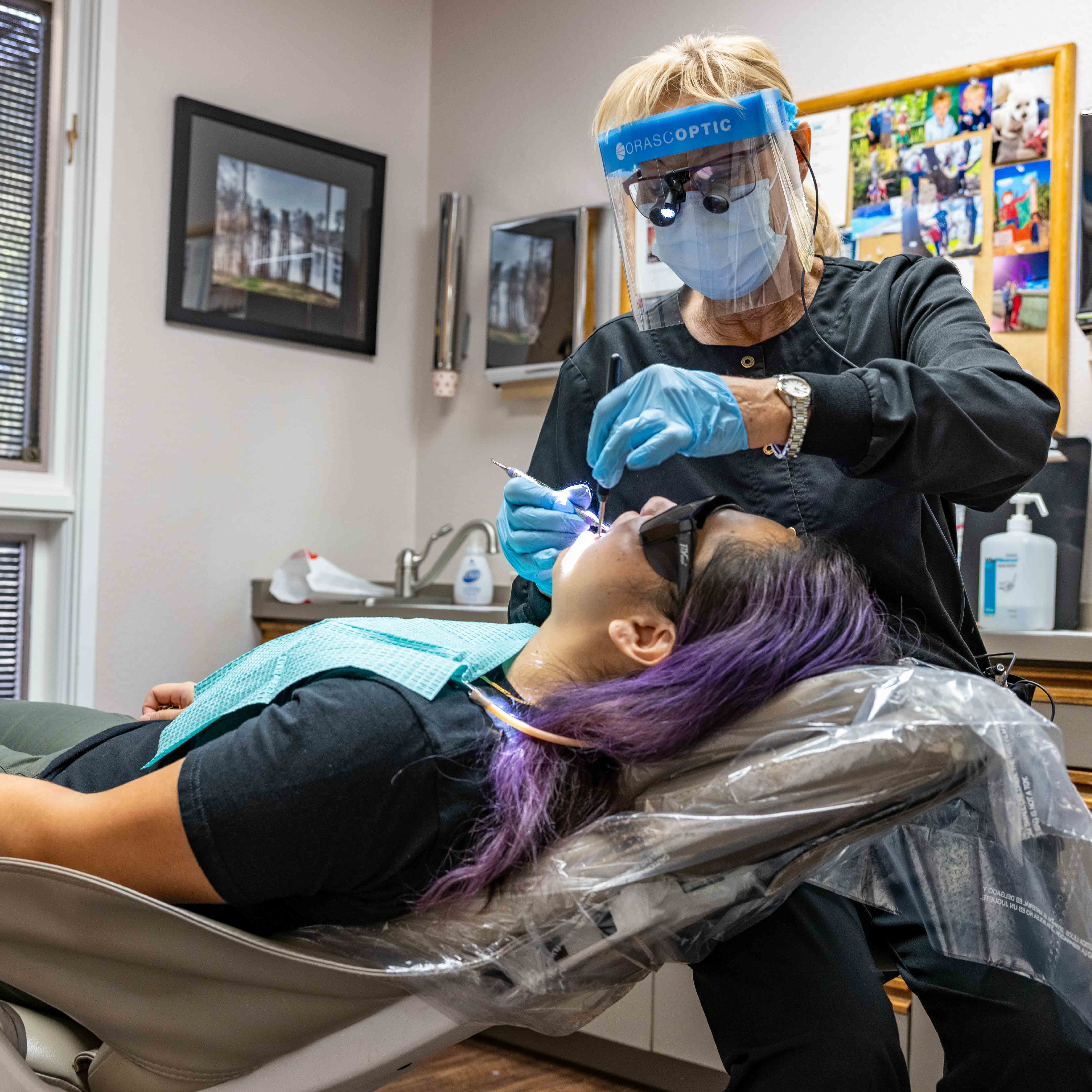 Dental hygienist at Bingham Dentistry cleaning a patient's teeth